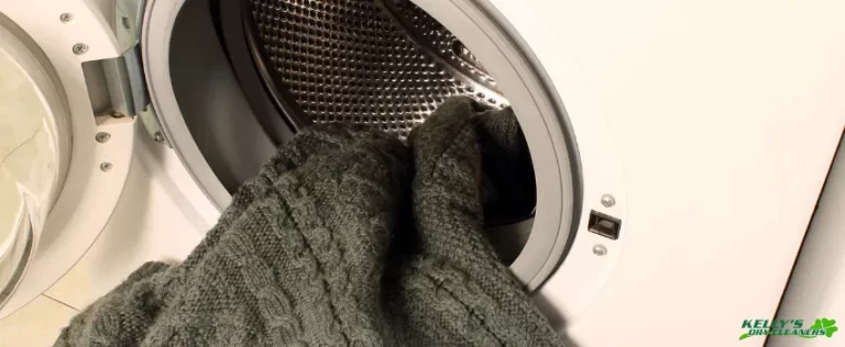 KDC - Grey swater halfway inside a washing machine