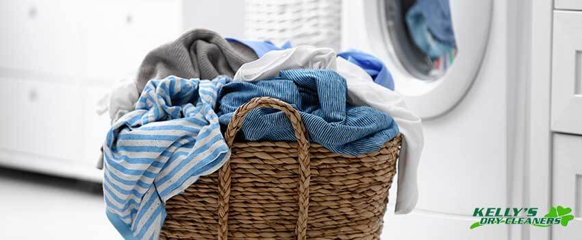 KDC Wicker basket with dirty laundry on floor indoors