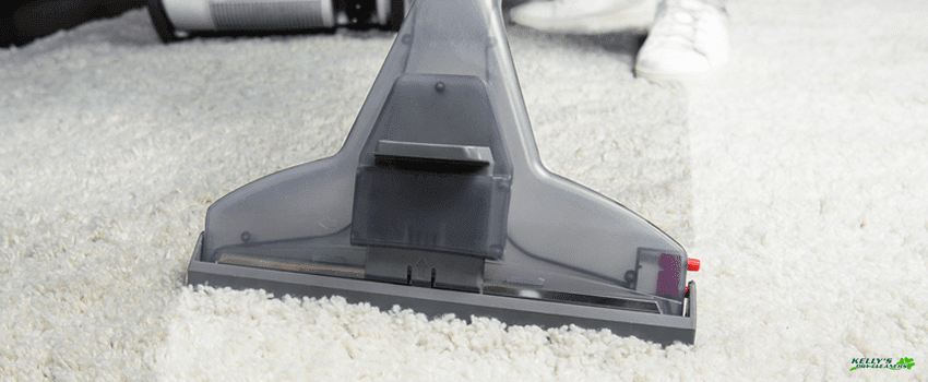 KDC-cropped shot of person cleaning white carpet with professional vacuum (1)